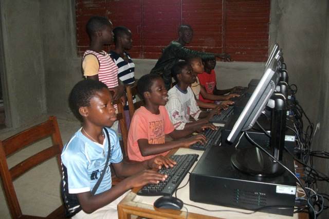 A close up image of 7 school children using donated desktop computers