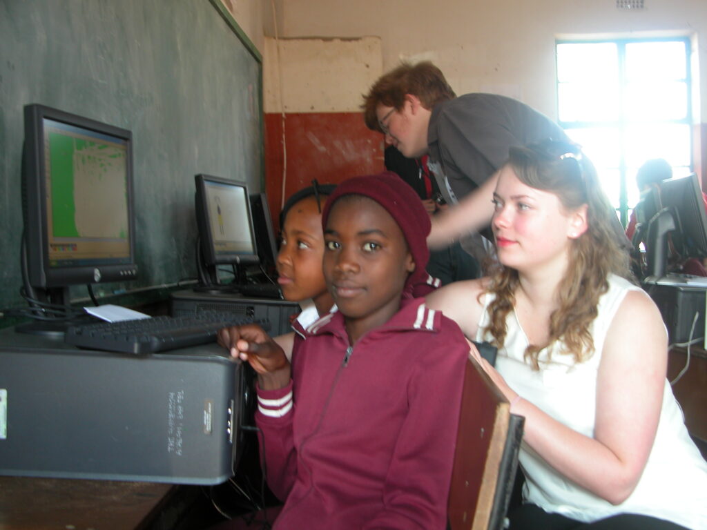 A group of school children using a donated computer from Reuising IT