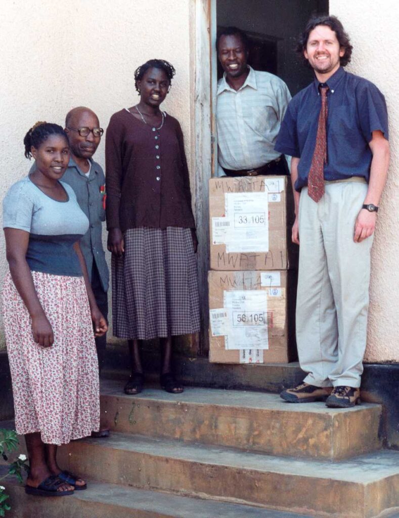 Ross Cockburn, the founder of Reusing IT, stood with people from Africa making a donation.