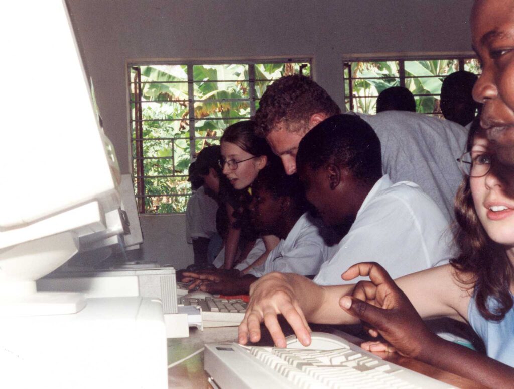 Close up image of school children in Tanzania using donated computers